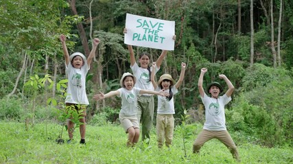Children join as volunteers for reforestation,children holding up signs to save the planet, earth conservation activities to instill in children are patient, selfless and loving nature.
