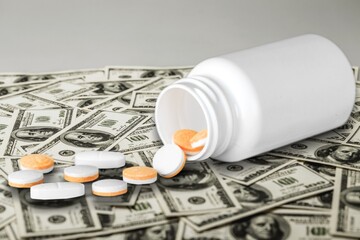 US dollars and oral drug against Covid-19. Concept of purchasing, buying or roll out tablets