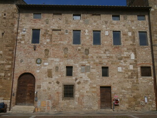 Podestà palace of Colle di Val d'Elsa with the heraldic coats of arms of the Podestà on the facade