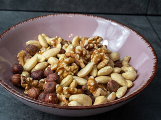 Mix nuts on a wooden background.