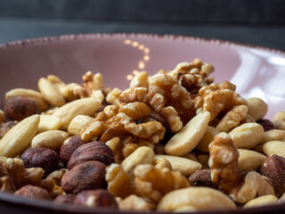Mix nuts on a wooden background.