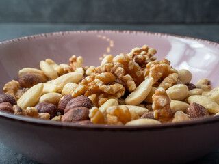 Mix nuts on a wooden background.