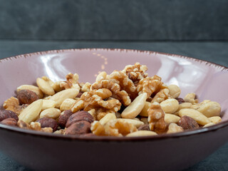Mix nuts on a wooden background.