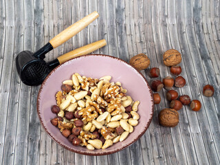 Mix nuts on a wooden background.
