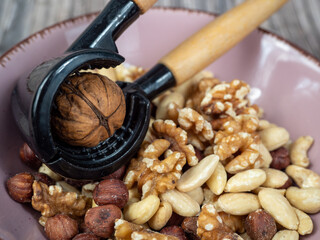 Mix nuts on a wooden background.