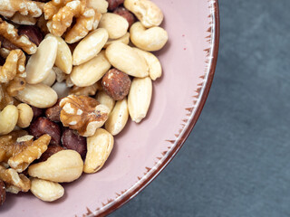 Mix nuts on a wooden background.
