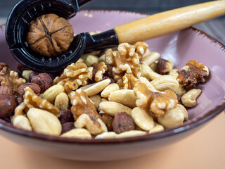 Mix nuts on a wooden background.