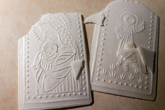 Warsaw, Poland - December 24, 2019: Traditional Christmas Polish wafer called oplatek broken for wishing for religious pasterka vigil service at St. John's Archcathedral in Warszawa