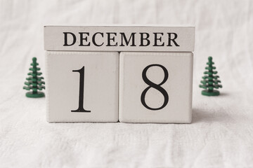 Save the date. December 18th. Day 18 of month, date calendar  and small Christmas trees on white...