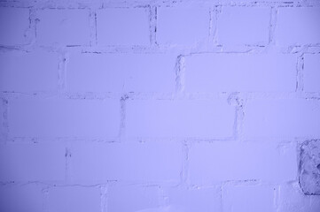 Brick wall texture background colored in trendy violet color