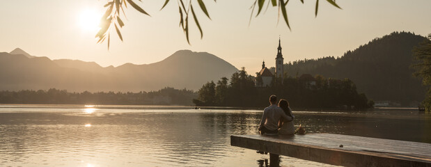a couple enjoying a sunrise at lake Bled