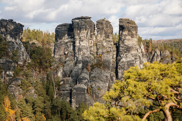 Fototapeta na wymiar Saxon Switzerland National Park, Germany, 6 November 2021: Basteiaussicht or Bastei Rock Formations in Elbe River Valley, Sandstone Mountains Path, autumn forest landscape at sunny day, rocky valley