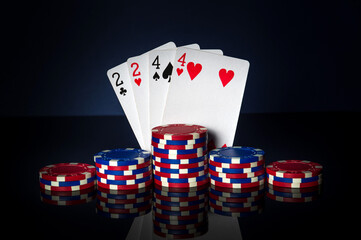 Poker game with two pairs combination. Chips and cards on black table. Successful and win