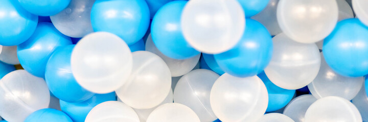 The background is made of plastic whites. Blue balls in the playroom