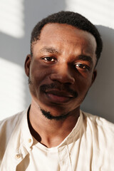 Obraz premium Close-up of African young man in shirt looking at camera isolated on white background