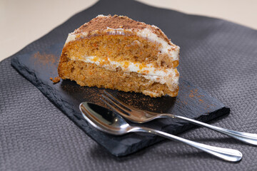 Porción de tarta de zanahoria en mesa de restaurante.