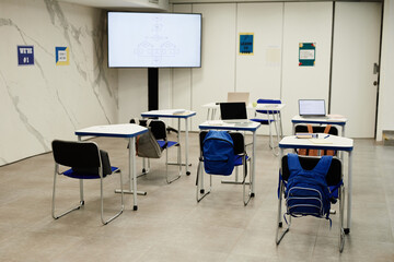 Background image of programming classroom in modern school with code on screen, copy space