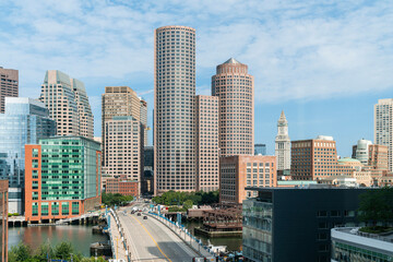 Fototapeta na wymiar Panoramic picturesque city view of Boston Harbour and Seaport Blvd at day time, Massachusetts. An intellectual, technological and political center. Building exteriors of financial downtown.