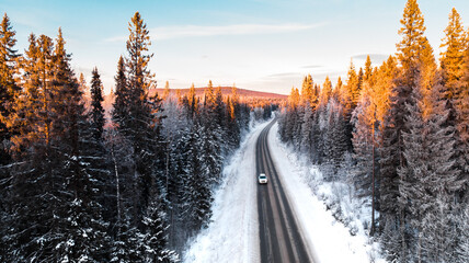 Natural background. Winter road in the forest from the height of a drone flight.