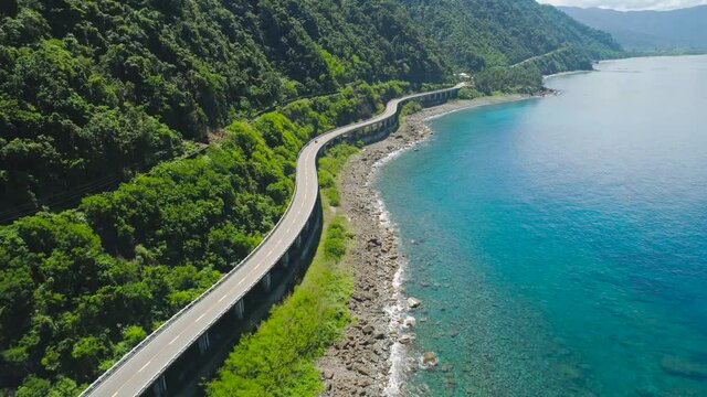 Bridge with highway along the seashore. Viaduct in the coast of Highway with bridge by coast sea near the mountains.