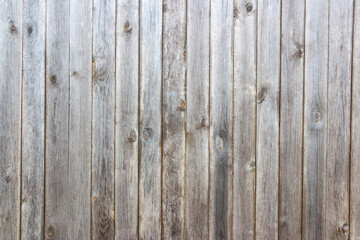 Naklejka premium Old grey wooden background with cracks and scratches in vintage style