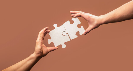 Hand connecting jigsaw puzzle. Business solutions, success and strategy concept. Man hands...