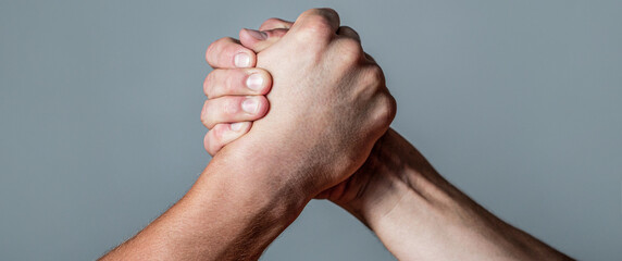 Man hand. Two men arm wrestling. Arms wrestling. Closep up. Friendly handshake, friends greeting,...