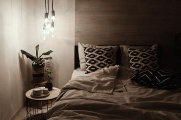 modern bedroom in light tones at night time