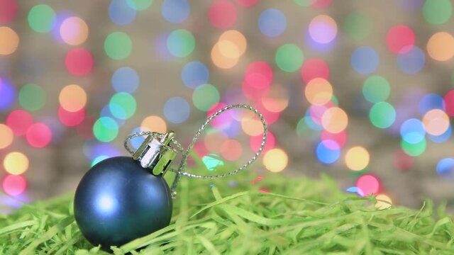 Christmas splash blue ball on the background of New Year's lights. Copy space. Multicolored lights out of focus. Beautiful footage, video for intro, transition, intro. UHD 4K.
