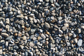 The texture of coarse gravel in full screen as a background.