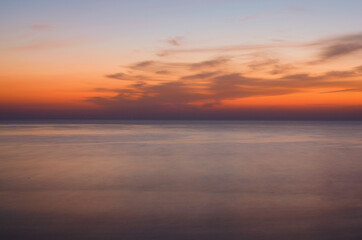 Naklejka na ściany i meble Abstract landscape view of Mediterranean Sea before sunrise. Blurred motion. Sunrise over a beach. Long exposure. Turkey
