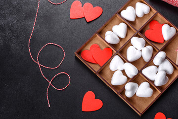 Beautiful background with white and red hearts on a dark table