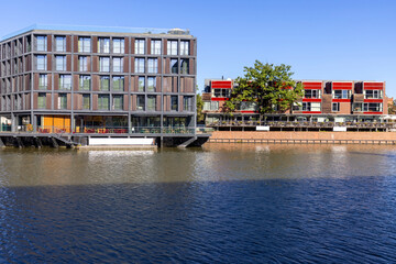 Modern apartment buildings on the bank of the river Odra on the island Kepa Mieszczanska, Wroclaw, Poland - obrazy, fototapety, plakaty