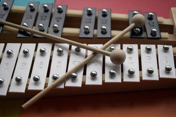 Black and white toy xylophone made of metal and wood (glockenspiel) 