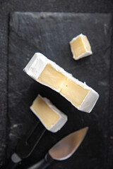 camembert or brie cheese head of soft cheese healthy meal food diet snack on the table copy space food background rustic. top view keto or paleo diet
