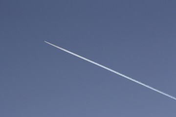 Plain trail in blue sky
