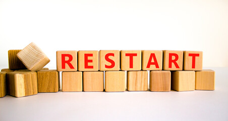 Restart and start symbol. The concept word Restart on wooden cubes. Beautiful white table, white...