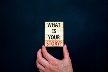 What is your story symbol. Concept words What is your story on wooden blocks. Businessman hand. Beautiful black table, black background, copy space. Business and what is your story concept.