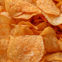 Fototapeta premium Potato chips or crisps . Close-up of potato chips or crisps. Food background.
