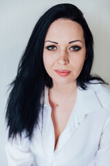 portrait of a beautiful fashionable brunette woman in a white shirt