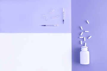 Mock-up bottle with spilled pills, syringes and ampoules toned in trendy color of year 2022. Cosmetology and medicine concept. Flat lay style.