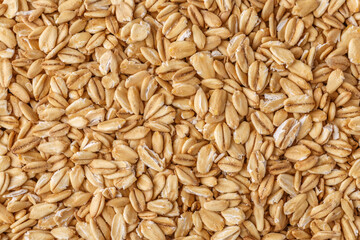 Rolled oat, oat flakes background or texture. Close up, directly above.Heap of dry rolled oats isolated.