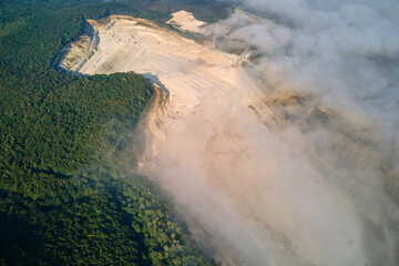 Aerial view of open pit mining of limestone materials for construction industry with excavators and...
