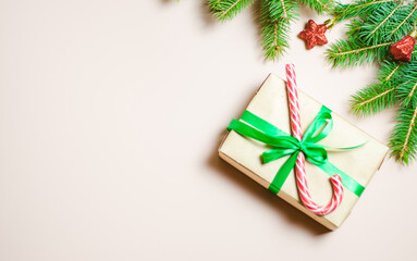 Handmade gifts decorated with colorful ribbons on a background decorated with fir branches. Blurry, defocused, selective focus. Copy space
