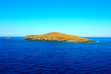 small island in the heart of the Aegean Sea, in the strait separating the famous Cycladic islands of Tinos and Andros