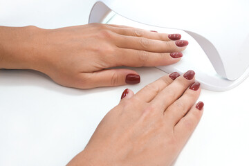 UV lamp gel polish manicure process. Salon procedure.