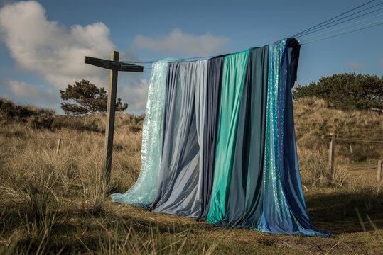 Abstract photo of different blue sheets on clothesline in nature
