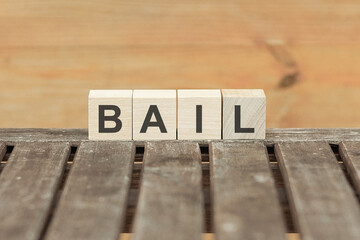Bail concept with wooden block on wooden table background
