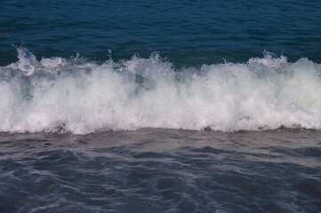 Sea wave with white foam. Blue sea. Sea coast. Russia, Sochi.