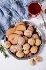 Cookies on a gray platter, tea and a warm blue scarf.